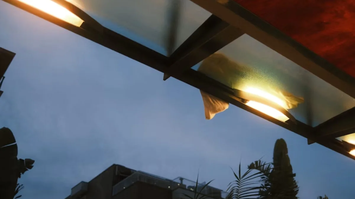 Tempered glass awning with sleek stainless steel brackets for a modern home entrance