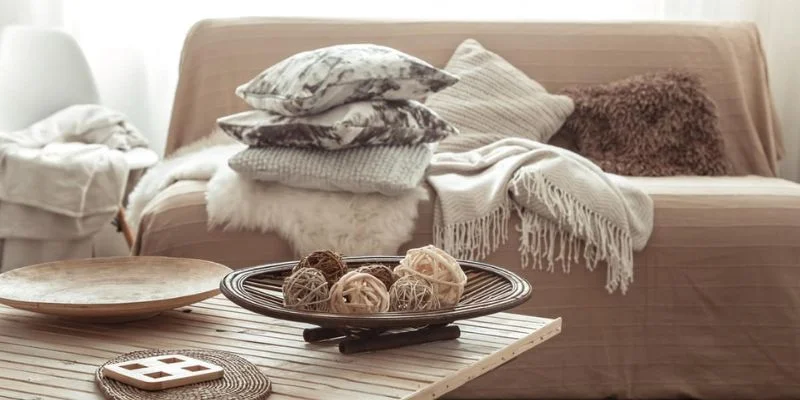 a living room with pillows and blankets on a wooden table