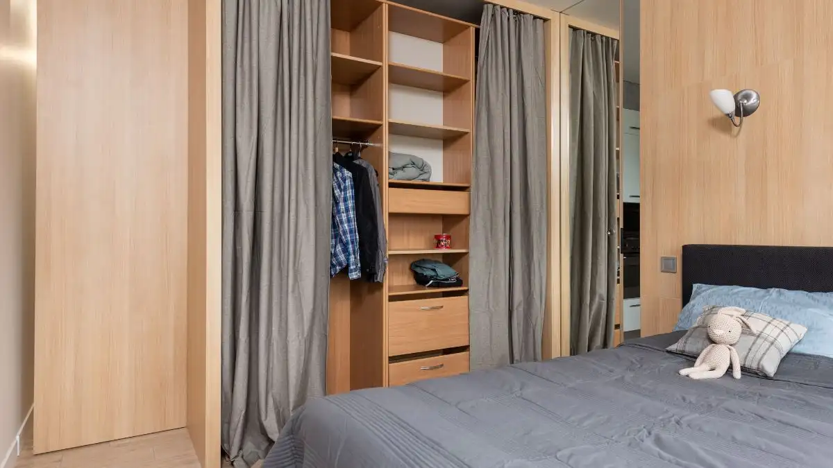 Bedroom storage ideas for small spaces with open shelving and curtain wardrobe