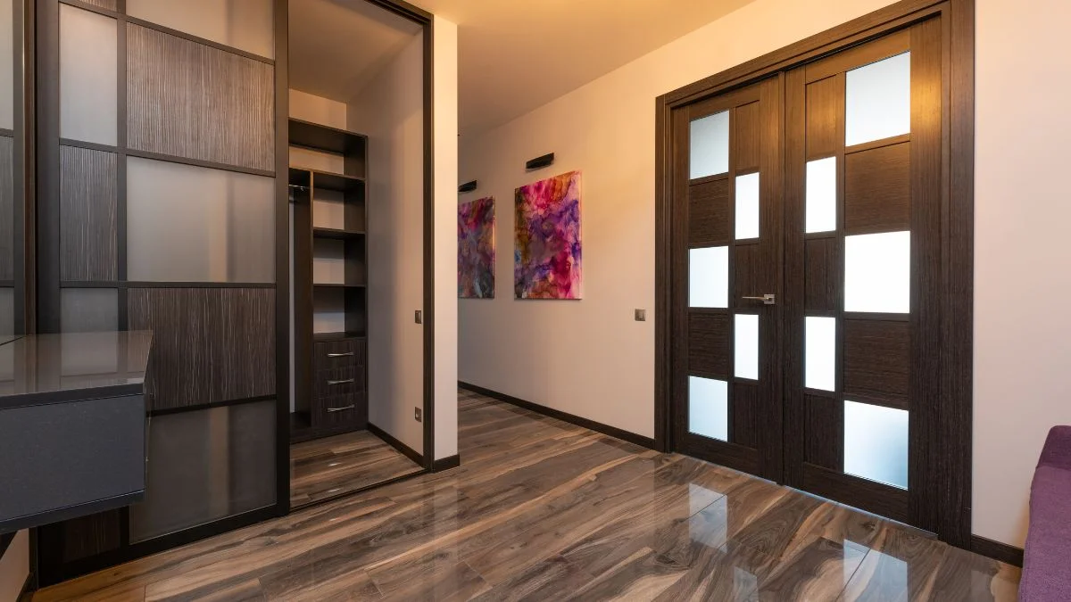Modern entryway design ideas with wood-paneled sliding closet doors and glass double doors