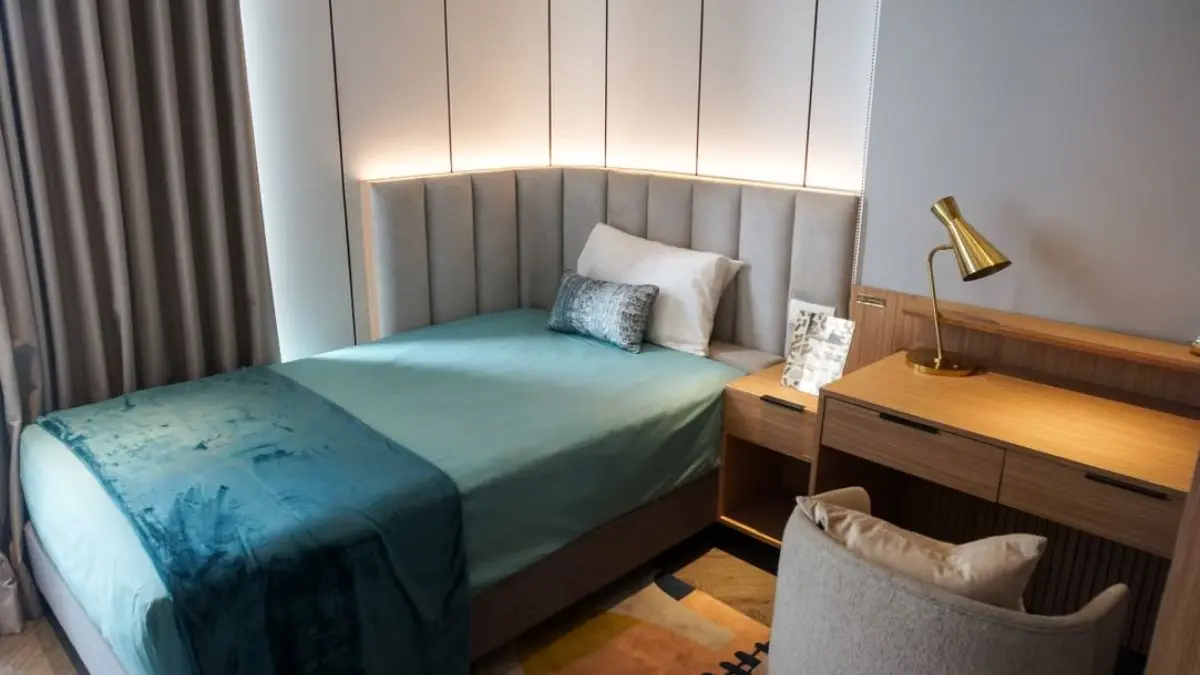 small bedroom decor ideas with upholstered headboard and built-in desk nook