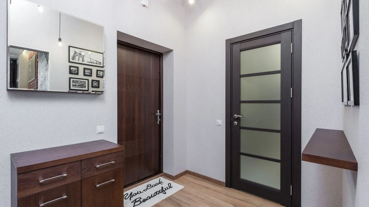 modern small entryway with wooden console table, mirror and rug